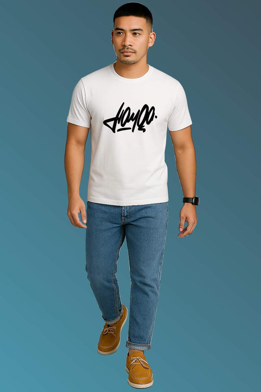 t-shirt featuring bold black stylized typography, worn with blue denim jeans and brown casual shoes. Set against a smooth blue gradient backdrop, the photo highlights modern streetwear style in a minimal, fashion-forward composition."